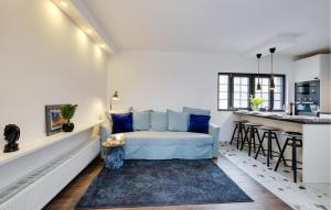 a living room with a couch and a kitchen at A Modern House In Nature in Popovača