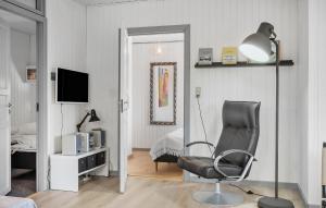 uma sala de estar com uma cadeira preta e um candeeiro em Stunning Home In Brkop With Wifi em Børkop