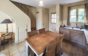 a kitchen with a wooden table and chairs at Nice Home In Saint-Laurent-De-La-Ca in Saint-Laurent-de-la-Cabrerisse +26 photos
