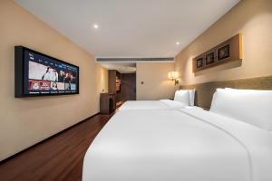 Postel nebo postele na pokoji v ubytování SSAW Hotel (Jiefangbei Hongyadong Branch)