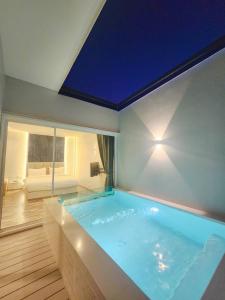 a large swimming pool in a room with a ceiling at Skyline Resort in Ban Khlong Lat Bua Khao