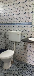 a bathroom with a toilet and a sink at Sea view Sun shine in Calangute +36 photos