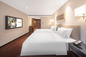 Postel nebo postele na pokoji v ubytování SSAW Hotel (Jiefangbei Hongyadong Branch)