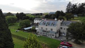 an aerial view of a large white house at Davy Cottage in Menheniot
