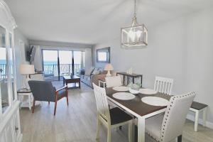 a dining room and living room with a table and chairs at Ocean Breeze Condo in Jensen Beach