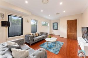a living room with a couch and a table at Aircabin - Carlingford - Sydney - 4 Beds House in Sydney