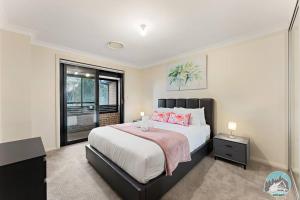 a bedroom with a large bed and a window at Aircabin - Carlingford - Sydney - 4 Beds House in Sydney