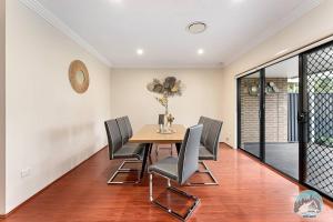 a dining room with a table and chairs at Aircabin - Carlingford - Sydney - 4 Beds House in Sydney