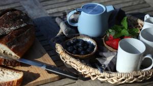 a basket of bread and berries on a table at The Getaway in Manyana +11 photos