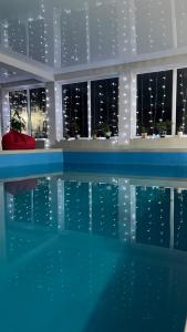 a swimming pool with a view of the city at night at Готель Колиба Колорит in Tatariv