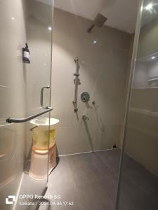a bathroom with a shower with a glass door at Sher-E-Punjab in Kolkata
