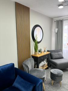 a living room with a blue couch and a chair at Stylish home in Linlithgow in Linlithgow