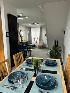 a dining room table with plates and glasses on it at Stylish home in Linlithgow in Linlithgow