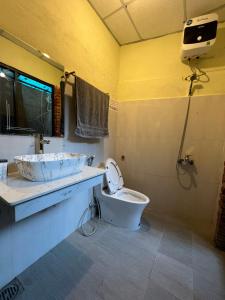 a bathroom with a sink and a toilet at Oasis Station in Hue