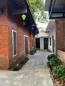 a brick building with a walkway in front of it at Oasis Station in Hue
