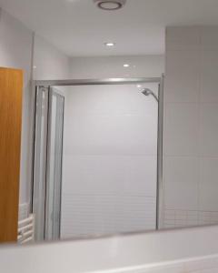 a mirror in a bathroom with a shower at TQ luxurious 2 bed flat in Birmingham