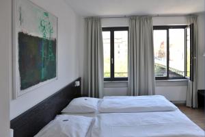 Postel nebo postele na pokoji v ubytování Tandem Hotel