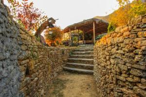 a stone wall with a set of stone steps at Back To Nature in Pokhara