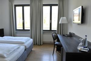 Postel nebo postele na pokoji v ubytování Tandem Hotel