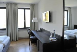 Postel nebo postele na pokoji v ubytování Tandem Hotel