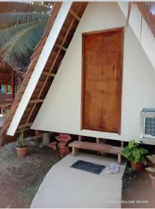 a small house with a wooden door and a porch at Fun Da House in San Juan