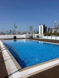 a large swimming pool on top of a building at Luxury Staycation Studio in Royal Neighbourhood in Dubai