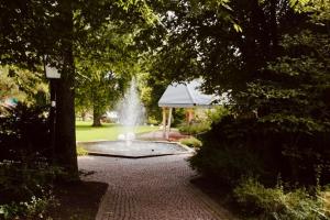 a fountain in the middle of a park at Ferienappartement mit Schwimmbad und Alpenblick in Höchenschwand