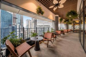 a restaurant with chairs and tables and a balcony at SSAW Hotel Chongqing Great World Jiefangbei in Chongqing