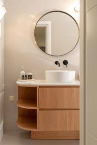 a bathroom with a sink and a mirror at Ros Solis Luxure House in Chania Town