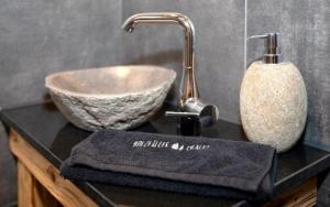 a bathroom sink with a bowl on a counter at Holzfäller-Chalet in Obdach