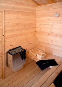 an inside of a wooden sauna with a bench at Holzfäller-Chalet in Obdach