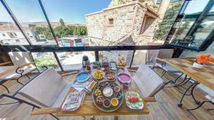 a table with plates of food on a balcony at Atax Cave House in Avanos