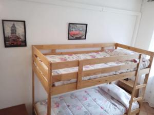 a wooden bunk bed in a room with two pictures at Villetta con parco vicino San Gimignano in Le Grazie