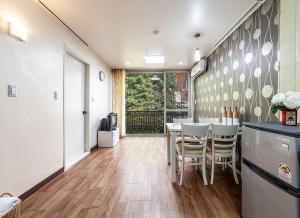 a kitchen and dining room with a table and chairs at HK Resort in Sokcho