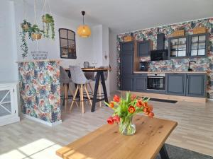 a kitchen with a vase of flowers on a table at Zur alten Scheune in Ochtendung