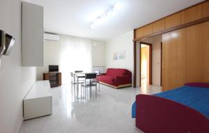 a bedroom with a bed and a dining room at Lovely Apartment In Parco Dei Tigli in Paestum +9 photos