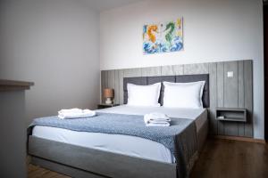 a bedroom with a bed with two towels on it at Queen's Garden Balchik apartment in Balchik