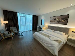 a hotel room with a large bed and a table at 52 The Grace hotel in Muar