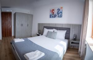 a bedroom with a large bed with two towels on it at Queen's Palace Balchik apartment in Balchik