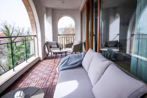 a living room with a couch and a balcony at Queen's Palace Balchik apartment in Balchik