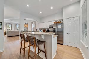 a kitchen with two bar stools and a counter top at The Sip at Sea in Gulf Shores