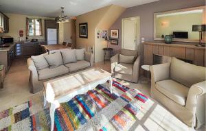 a living room with two couches and a coffee table at Stunning Home In Saint-Laurent-De-La-Ca in Saint-Laurent-de-la-Cabrerisse