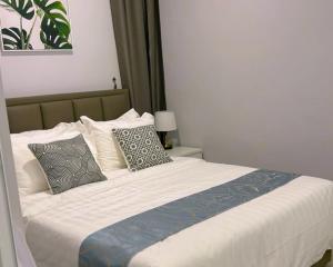 a bedroom with a large bed with pillows at Grace Suite @ The Shore KK in Kota Kinabalu +25 photos
