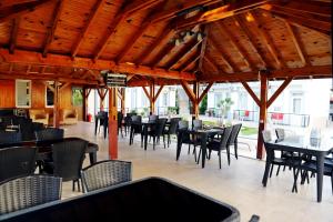 a dining area with tables and chairs in a restaurant at Akın Apart and Hotel in Antalya