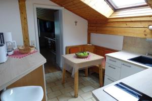 a small kitchen with a small table and a window at FeWo-Franzi 1-4 Persca45qmDG in Buching