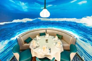 a dining room with a table in the middle of the ocean at Shanghai Haichang Ocean Park Resort Hotel in Shanghai