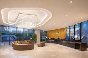 a lobby of a building with a chandelier at Holiday Inn Chengdu Airport, an IHG Hotel in Chengdu