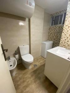a bathroom with a toilet and a sink at Playa Rompido in Huelva +19 photos