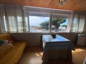a living room with a table and a window at Playa Rompido in Huelva