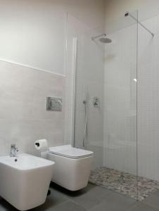a bathroom with a shower and a toilet and a sink at Appartamento Ca' Mia in Montà +20 photos